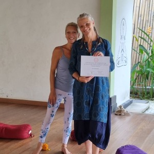 student-receiving-her-accredited-certification-in-our-yin-yoga-teacher-training-50-hour-program-in-bal